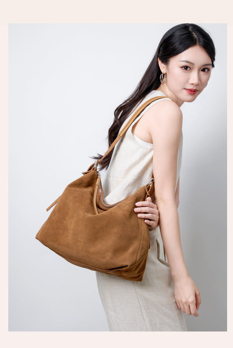 Caramel tote worn across the model's side