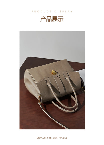 Taupe leather satchel bag with gold-tone lock clasp and top handles
