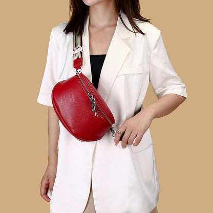 Red crossbody bag modeled over a white blazer