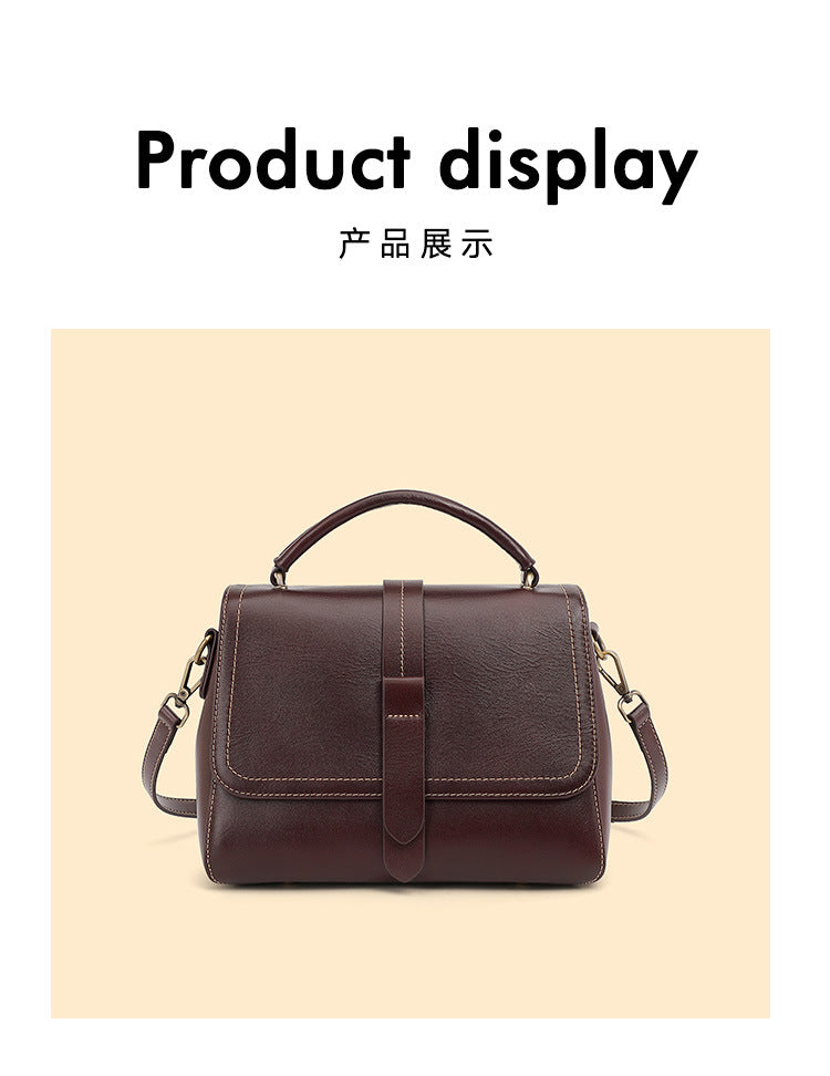 Front view of the wine brown cowhide leather Boston crossbody bag with flap and center strap detail