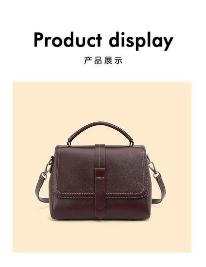 Front view of the wine brown cowhide leather Boston crossbody bag with flap and center strap detail