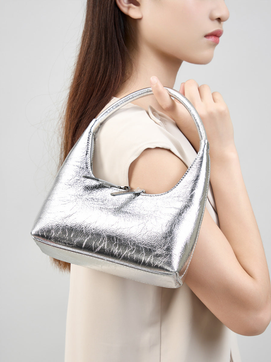 Model wearing silver mini hobo bag over the shoulder