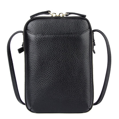 Black pebbled cowhide vertical crossbody phone bag with top zip and adjustable strap