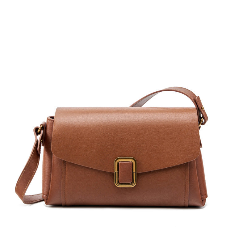 Chocolate brown cowhide leather crossbody bag with gold-tone buckle on white background
