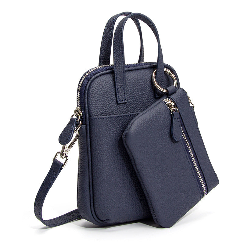 Deep Navy Mara leather crossbody bag showing top handles and side ring