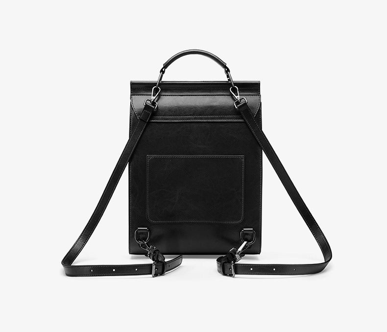 Back view of black backpack showing rear slip pocket and straps