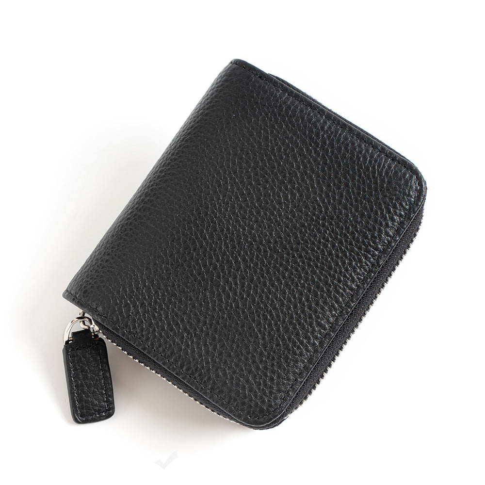 Black cowhide leather bi-fold wallet with zip closure on white background
