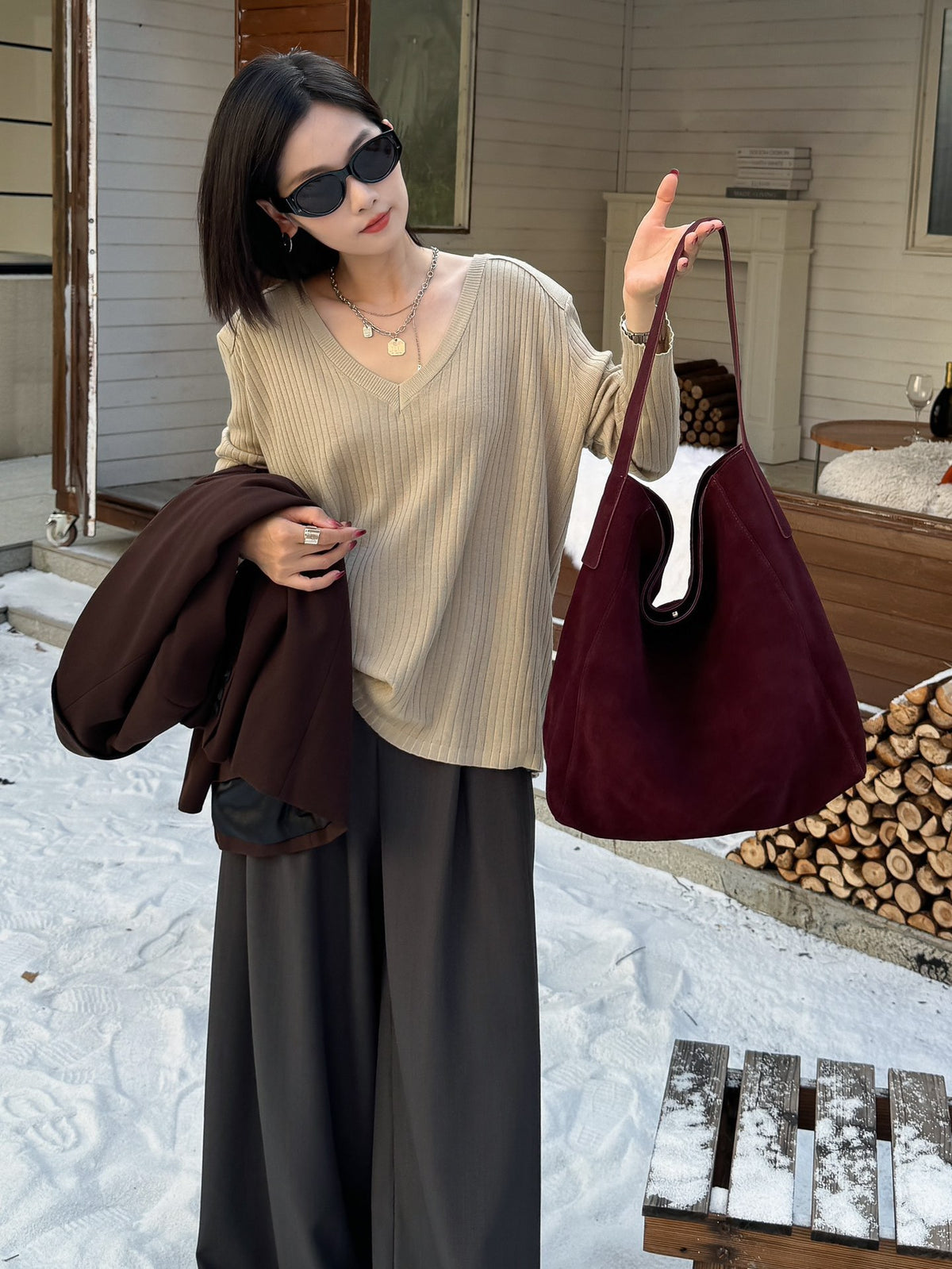 Burgundy tote styled with a neutral sweater