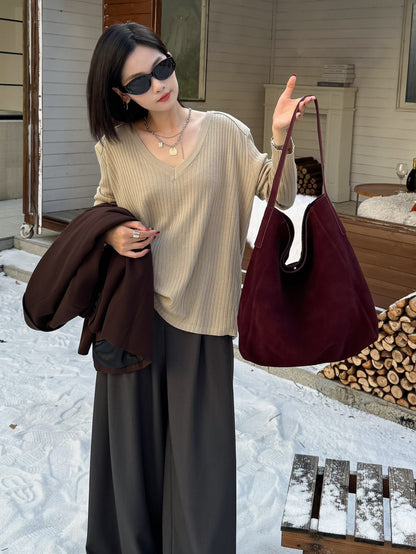 Burgundy tote styled with a neutral sweater
