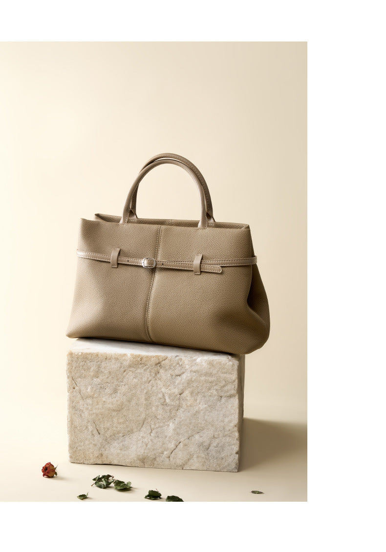 Elephant gray tote bag displayed on stone block with rose petals