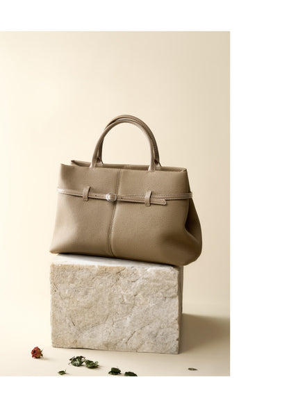 Elephant gray tote bag displayed on stone block with rose petals
