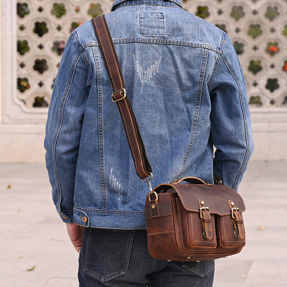 Rear view of a person carrying the leather camera bag