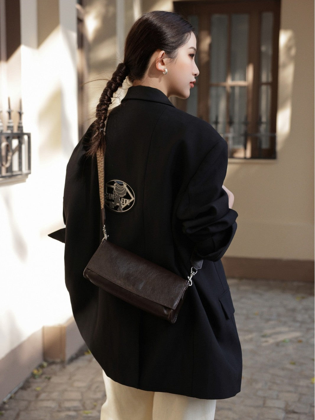 Coffee bag styled across the back with a dark jacket