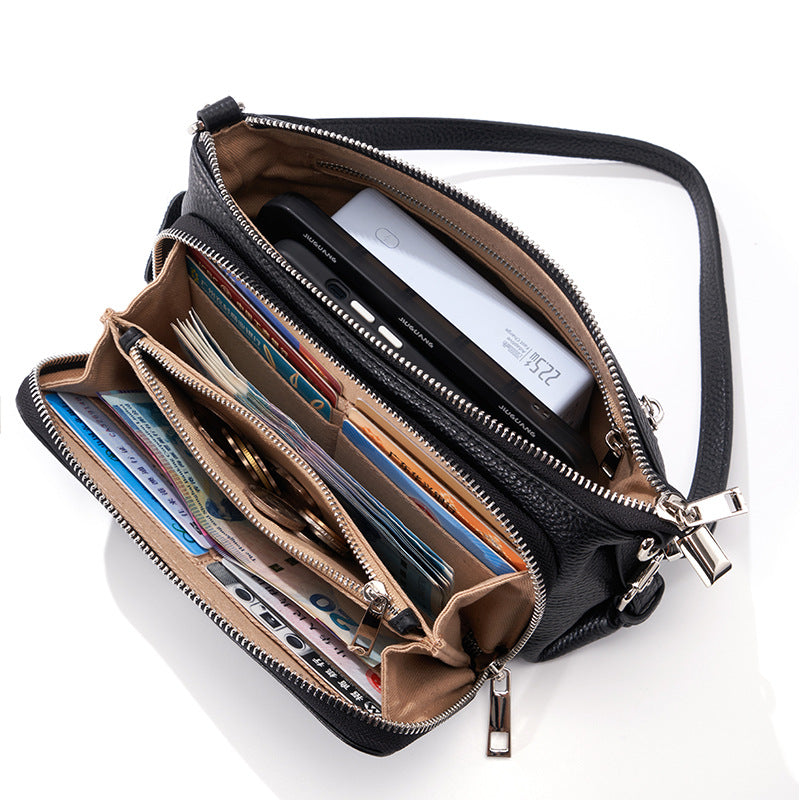 Close-up of black leather bag interior with cards and money