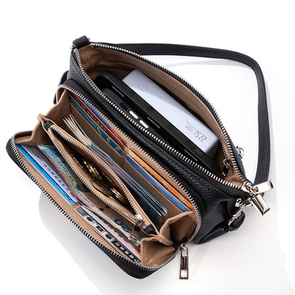 Close-up of black leather bag interior with cards and money