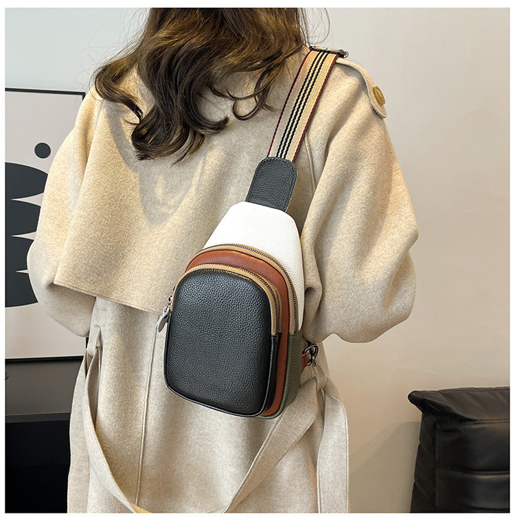 Black-front colorblock sling bag shown on a model