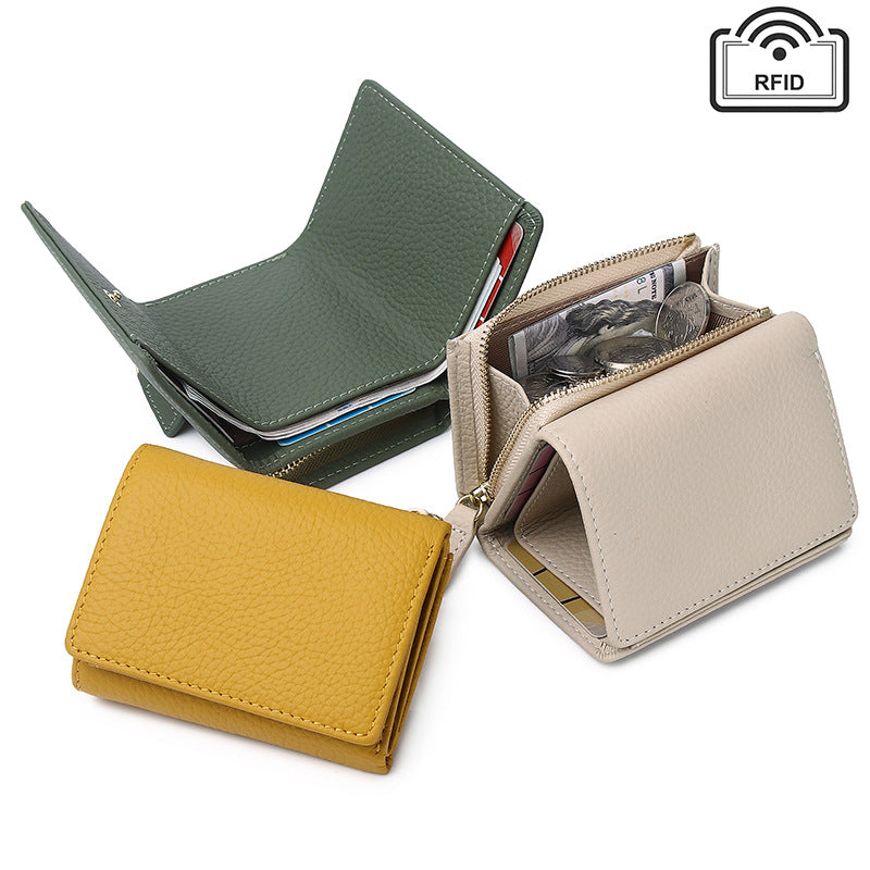 Group of green, ivory, and yellow leather wallets displayed together