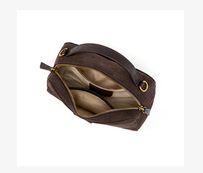 Open dark brown crossbody bag showing zip closure and interior pockets