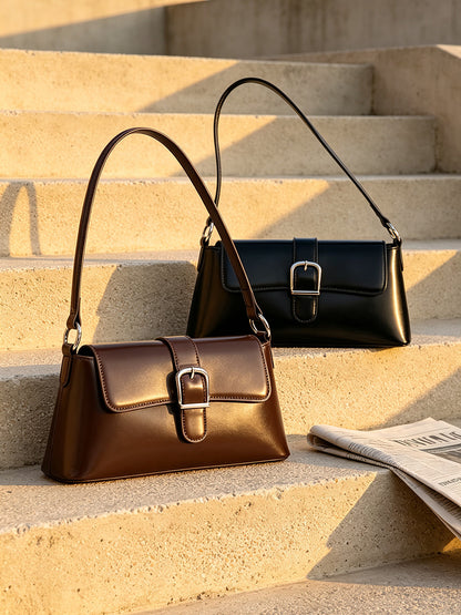 Black and brown baguette bags resting on concrete steps