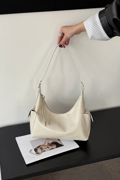Beige leather shoulder bag shown from the front