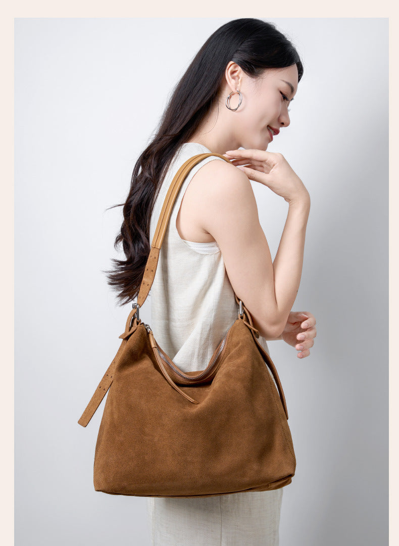 Khaki tote worn on the shoulder in a lifestyle photo