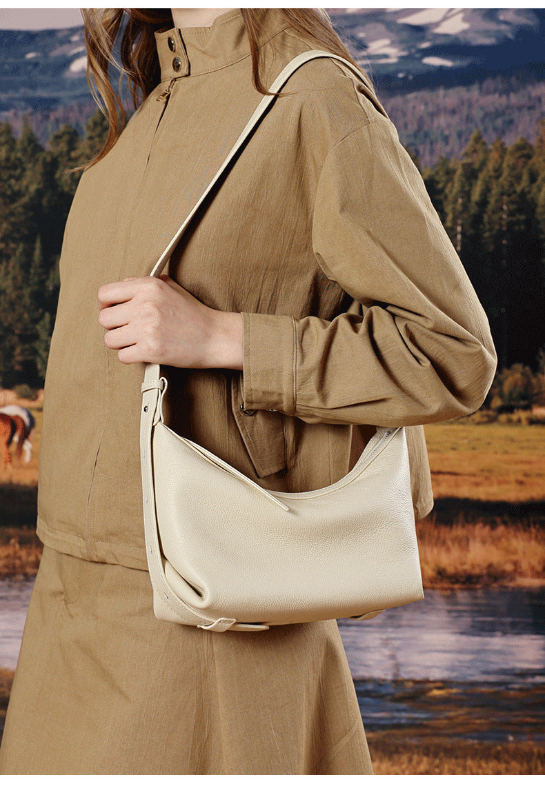 Ivory white hobo bag worn crossbody in nature