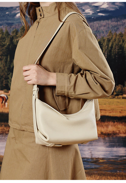 Ivory white hobo bag worn crossbody in nature