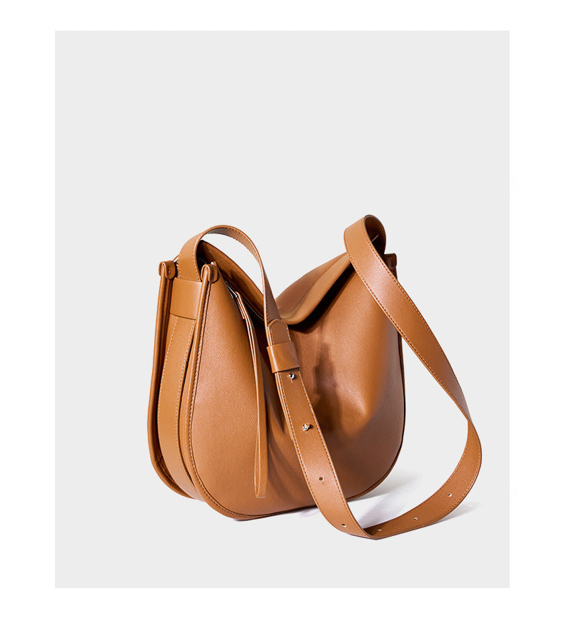 Rear view of tan leather hobo bag showing adjustable strap hardware