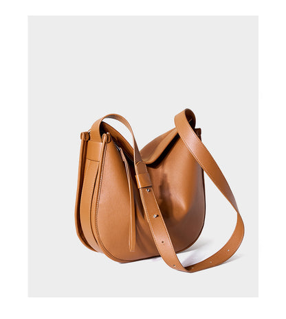 Rear view of tan leather hobo bag showing adjustable strap hardware