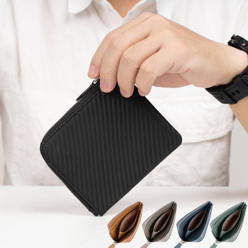 Carbon black textured leather wallet held in hand showing slim profile