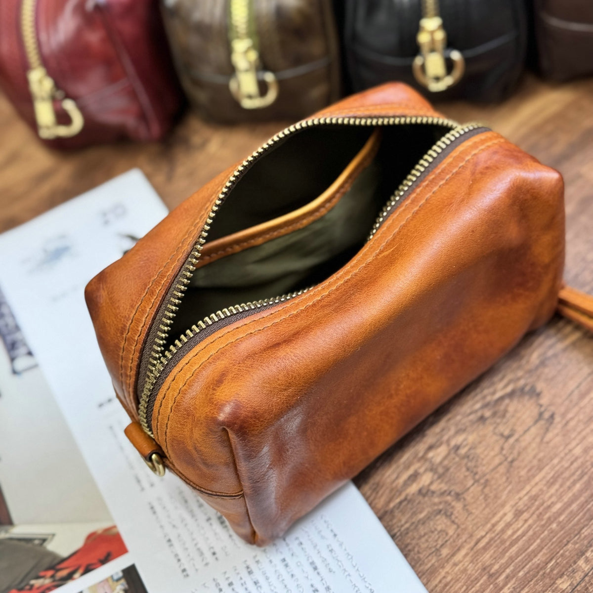 Open brown leather pouch showing zipper and interior lining