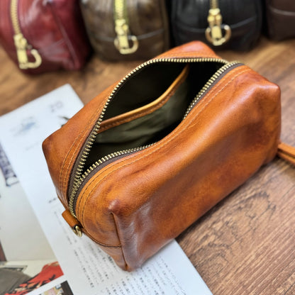Open brown leather pouch showing zipper and interior lining