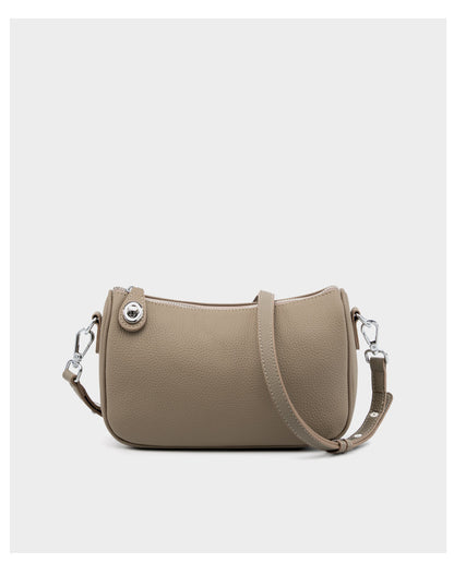 Front detail of taupe bag with silver hardware on white background