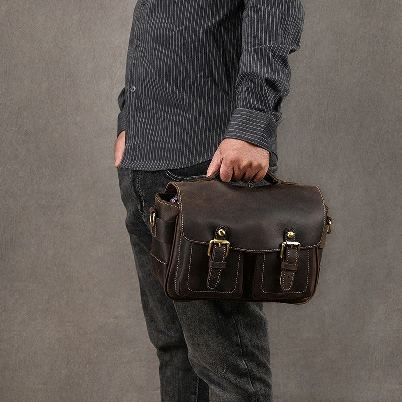 Dark brown camera bag carried by its top handle