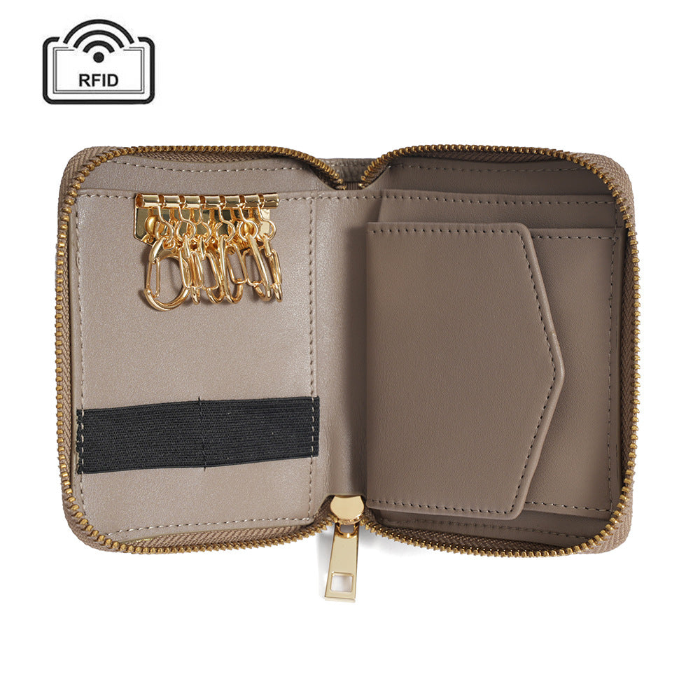 Open interior of taupe wallet showing key hook, card slots, and bill compartment