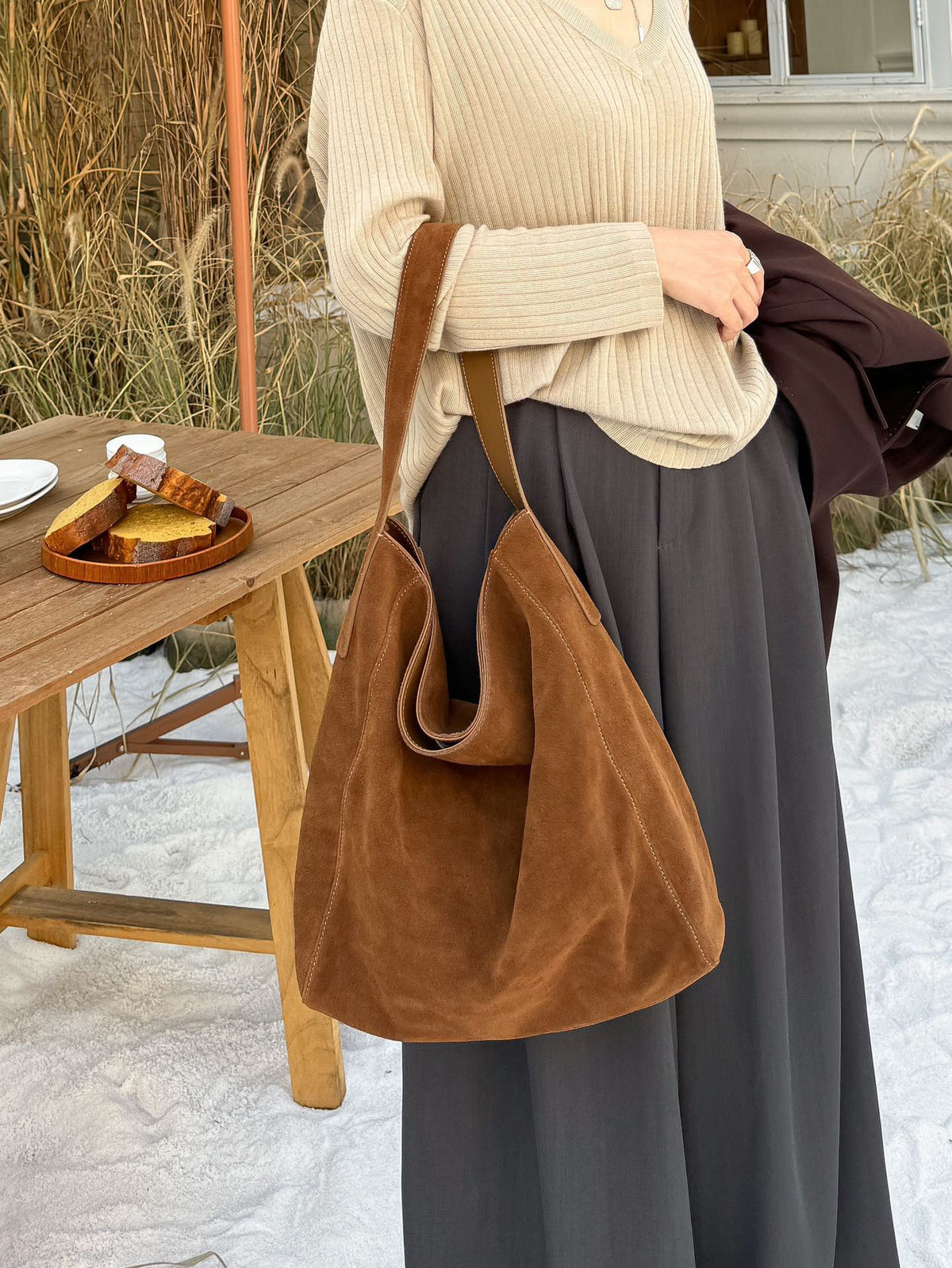 Caramel tote shown with a sweater and winter outfit