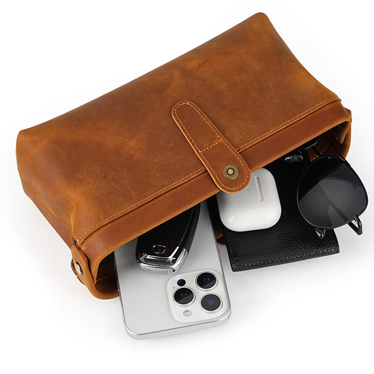 Open brown cowhide pouch with phone keys coins and sunglasses