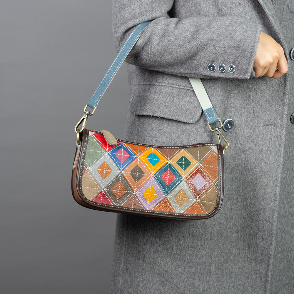 Multicolor patchwork shoulder bag shown worn against a coat