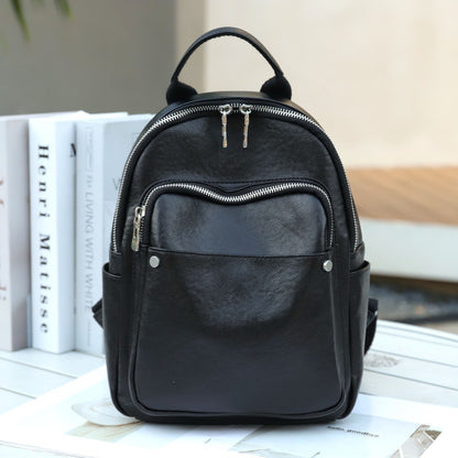Black cowhide backpack front view with front zip pocket
