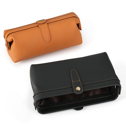 Leather cosmetic pouch shown in orange and black with the lining visible
