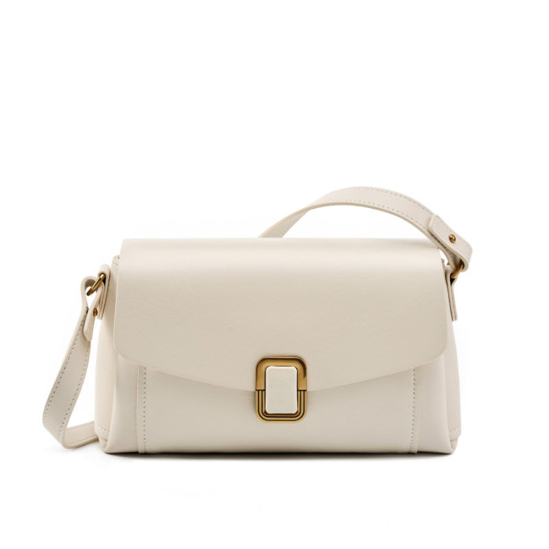 Cream white cowhide leather crossbody bag with gold-tone buckle on white background