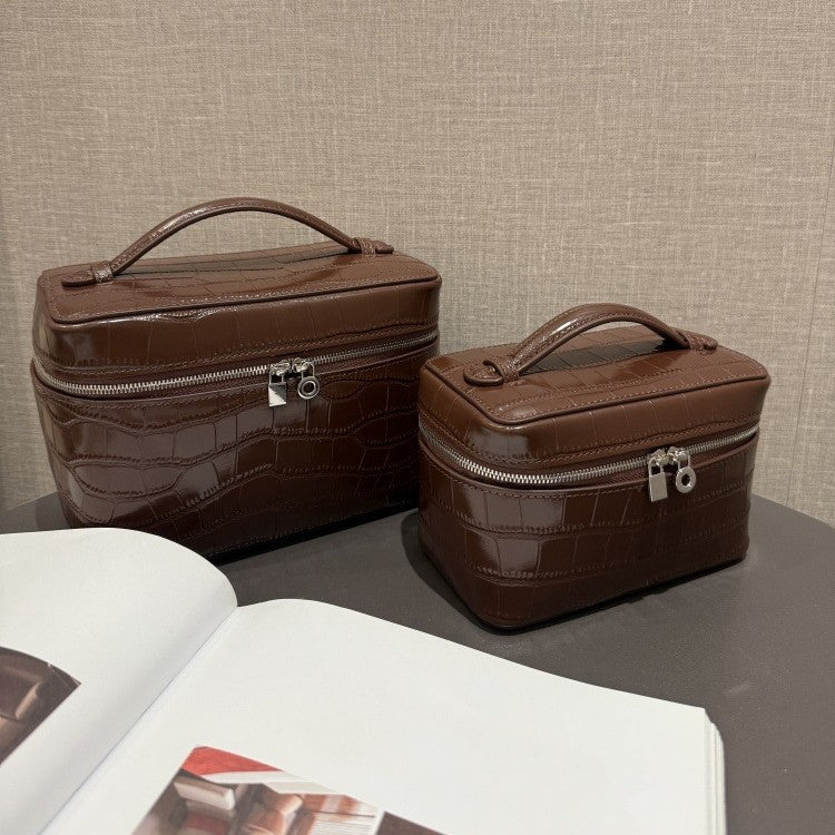 Large and small chocolate cowhide cosmetic pouches with top handles