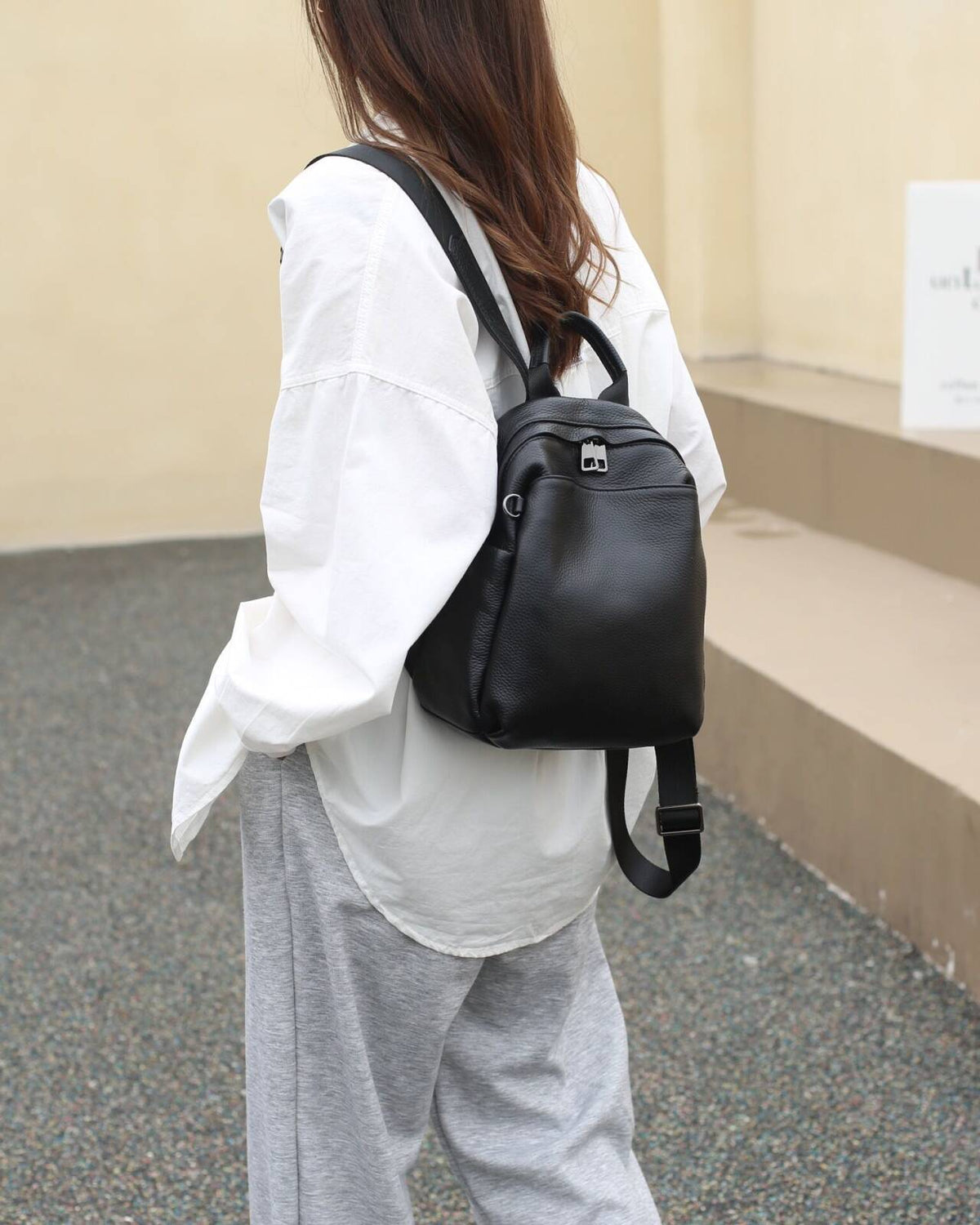 Black pebbled cowhide backpack worn on the back