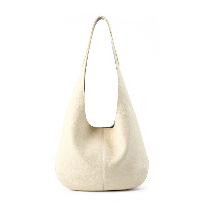 Off-white cowhide leather bucket tote bag on white background