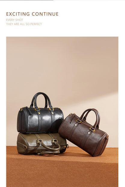 Stacked display of black, olive green, and dark brown Boston bags