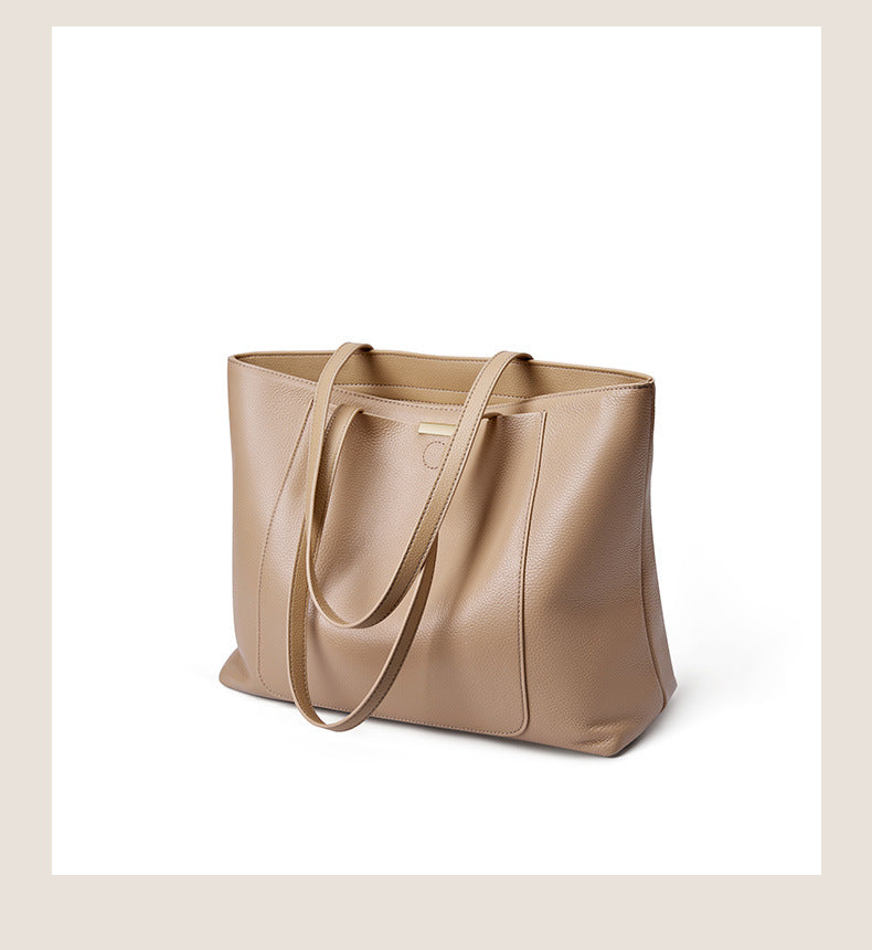Three-quarter angle of apricot pebbled leather tote with straps visible
