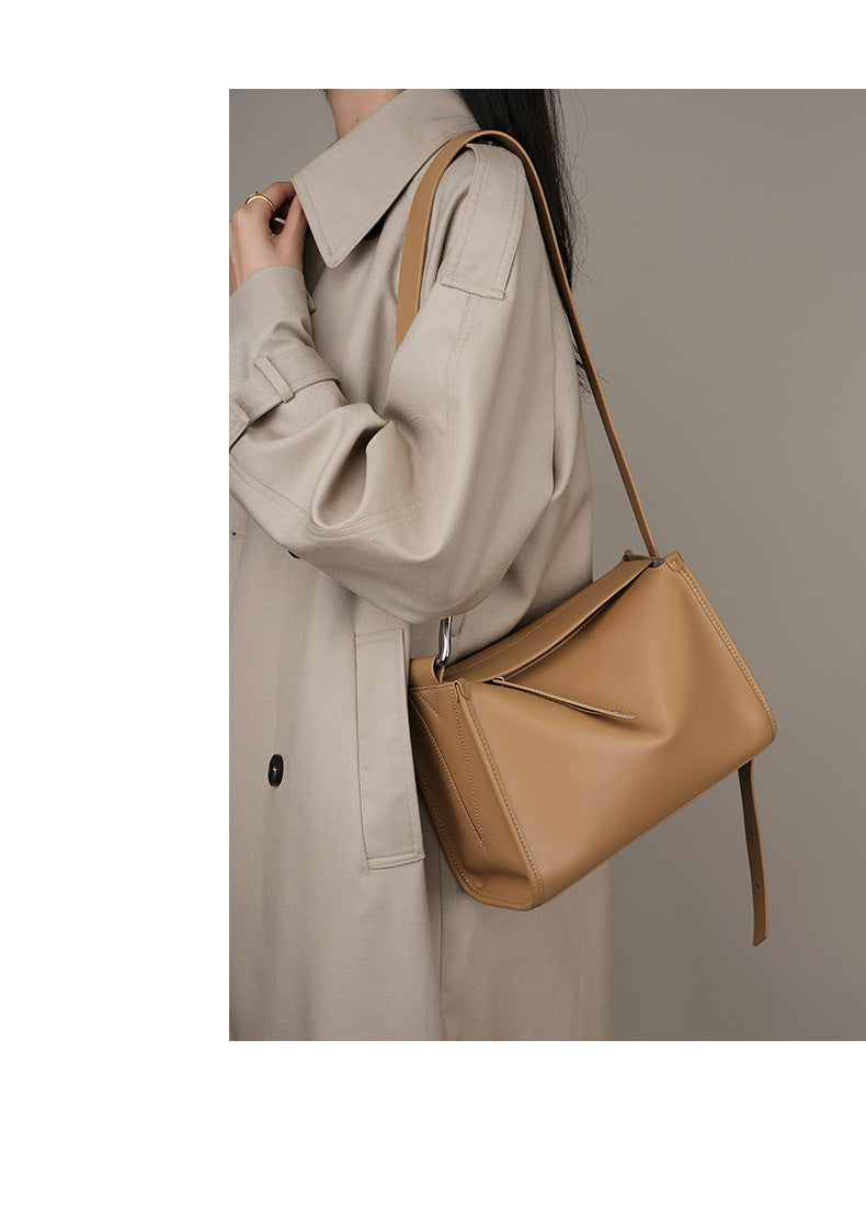 Apricot pillow bag worn over shoulder in lifestyle shot