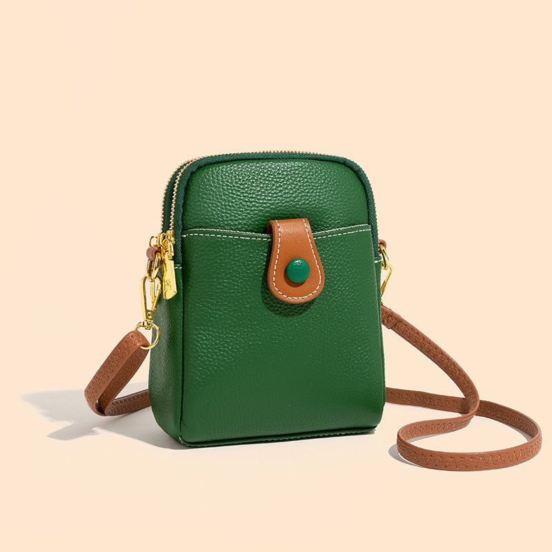 Front view of green pebbled cowhide small bag with gold-tone hardware and snap tab