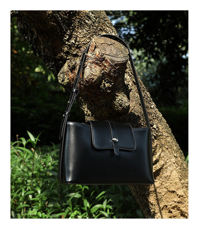Bottom view of brown leather bag showing stitching
