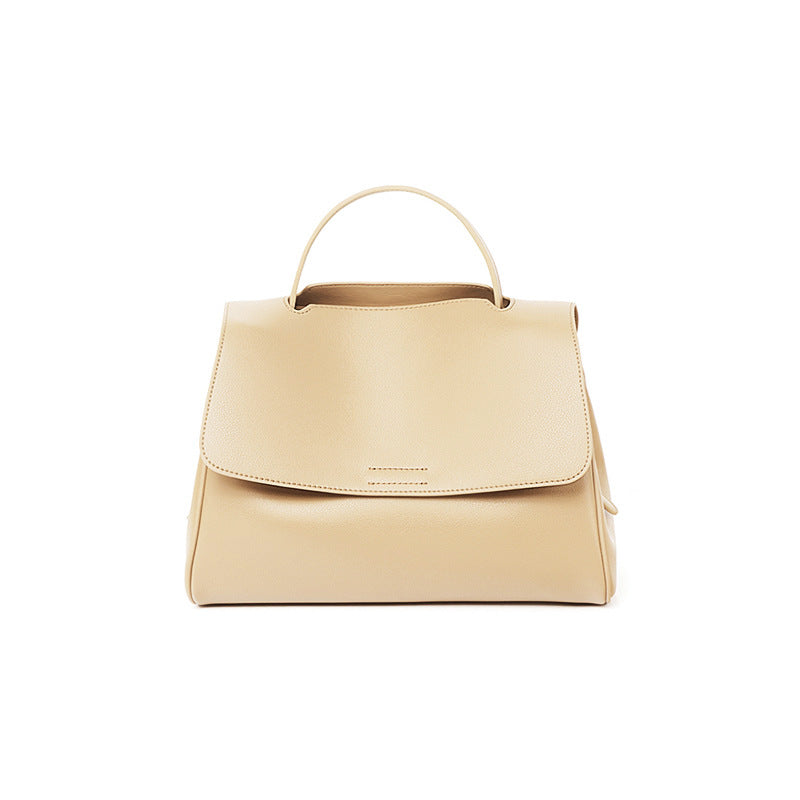 Apricot cowhide leather top-handle bag with flap closure on white background